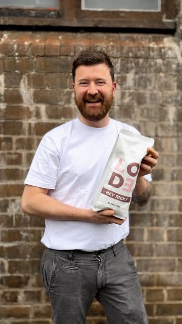 A customer holding a Lode paper bag