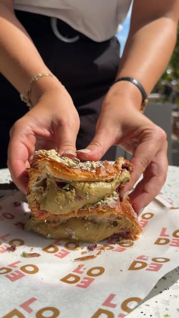 Hands pulling apart a filled pastry